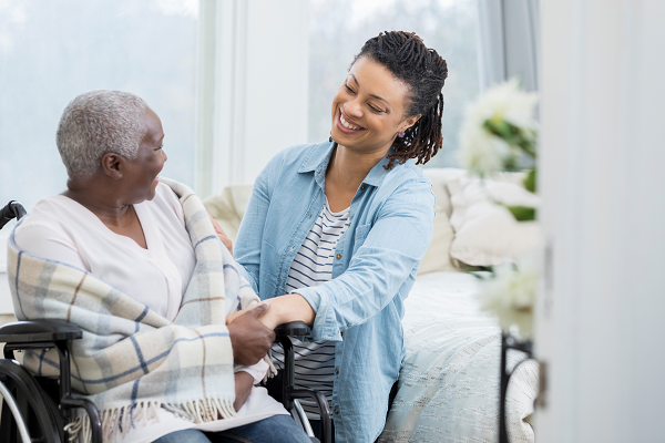 Personal Support Worker assisting a patient in a wheelchair